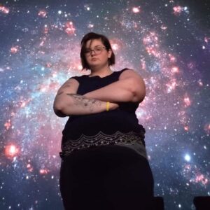 profile picture of Sarah Parker standing in front of a background showing the cosmos